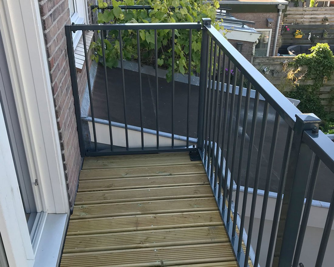 Goedkoop hekwerk in standaardsecties langs een houten terras